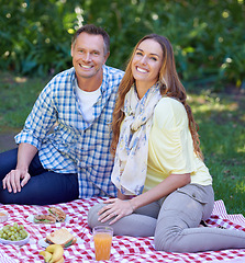 Image showing Portrait, picnic and couple with love, smile and happiness with romance and Valentines day with marriage. Outdoor, man or woman on the ground, relationship or anniversary with celebration or vacation