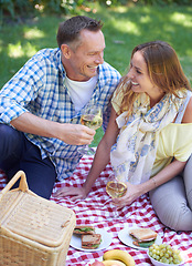 Image showing Couple, picnic and alcohol for bonding in outdoor nature, love and romance in relationship on weekend. Wine glasses, conversation and people on date in countryside, adventure and forest for happy