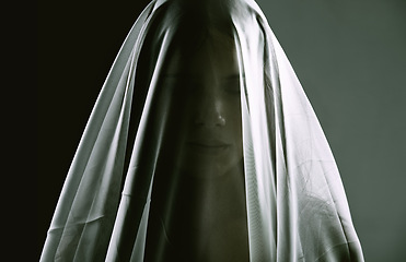 Image showing Woman, veil and person as ghost, spirit and surreal for scary, death and horror on dark background. Creepy, dramatic and female silhouette as spiritual for halloween, witchcraft and terror in studio