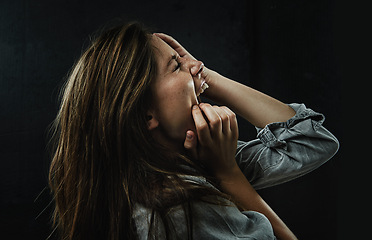 Image showing Profile, stress and horror with woman shouting in studio on black background for reaction to fear. Phobia, anxiety and mental health with scared young person screaming in dark for nightmare or terror