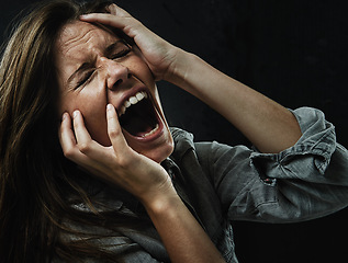 Image showing Face, stress and horror with woman yelling in studio on black background for reaction to fear. Phobia, mental health and breakdown with scared young person in dark for drama, nightmare or terror