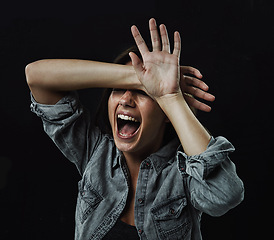 Image showing Hands, stress and horror with woman screaming in studio on black background for reaction to fear. Crazy, anxiety and mental health with young person screaming in dark for drama, nightmare or terror