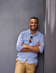 Image showing Man, smile and cool fashion in portrait by wall background, style and gen z outfit in outdoors. Happy black male person, university student and pride for aesthetic, confident and trendy clothes