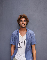 Image showing Crazy, funny and portrait of young man by wall for comic, playful or comedy joke expression. Silly, goofy and face of confident male person from Colombia by gray background with mockup space.