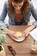 Image showing Top view, woman and coffee in cafe for relax, breakfast and leisure break with sugar, sunglasses and notebook. Above, person and cappuccino with art, pattern or foam in restaurant or diner in morning