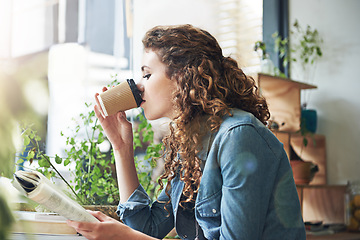 Image showing Book, drinking coffee and window with woman reading at table as customer for break, caffeine or literature. Cafe, glass or knowledge and young student in restaurant to relax with story or novel