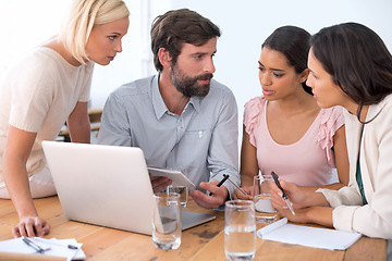 Image showing Group, laptop and business people in discussion, planning or brainstorming on notebook in startup. Team, computer and serious employees in collaboration, strategy or creative copywriter in meeting