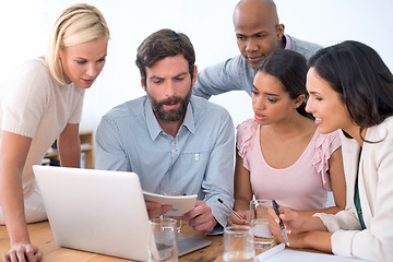 Image showing Group, notebook and business people in discussion, planning or brainstorming ideas in startup. Teamwork, laptop and serious employees in collaboration, diversity and creative copywriter in meeting