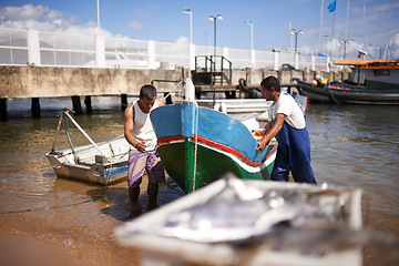 Image showing Lake, boat and fishermen by water for fishing industry in sea by outdoor dock for small business. Teamwork, labour and male people working with vessel at ocean harbor, marina or pier by shipyard.