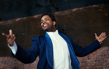 Image showing Man, smiling and entertainment for performance, event, celebration or musical at carnival or street show. African male person and joyful from Amsterdam with suit and shirt for concert or opera choir