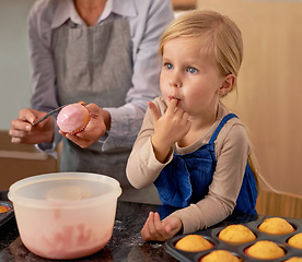 Image showing Child, baking and eating icing in kitchen for cupcake decoration or hungry for sweet snack, helping or ingredients. Teamwork, girl and finger for recipe taste in home for youth bonding, food or fun