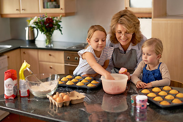 Image showing Grandmother, children and baking cupcakes or helping with icing decorations or learning creativity, bonding or teamwork. Woman, siblings and sweet treats or teaching with ingredients, snack or fun
