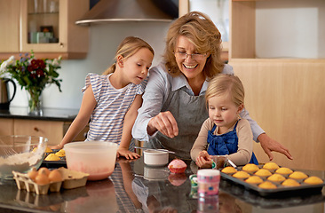 Image showing Grandma, kid and baking with teaching, smile and decorating for cheerful bonding together at home. Happy, pensioner or girl child with cupcake, laugh or icing for creative, playful or fun in kitchen