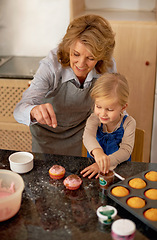 Image showing Grandmother, child and baking cupcakes or sprinkles with icing decorations or learning creativity, bonding or teamwork. Female person, girl and sweet treats or teaching with ingredients, snack or fun