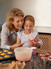 Image showing Grandmother, child and baking cupcake in kitchen or helping with decoration or creative icing, sprinkles or teamwork. Female person, girl and youth learning at home or ingredients, recipe or dessert