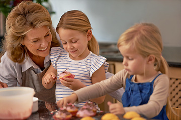 Image showing Grandmother, children and baking cupcake or teaching with icing decorations or learning creativity, bonding or teamwork. Woman, siblings and sweet dessert or helping with ingredients, snack or fun