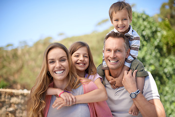 Image showing Parents, children and portrait with smile for travel together or vacation bonding in summer or family, sunshine or relax. Mother, daughter and siblings on shoulders in Florida or garden, park or love