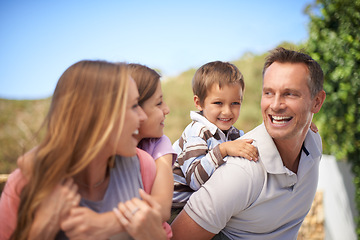 Image showing Family, piggyback and playful in outdoor on vacation, bonding and love in countryside on summer holiday. Parents, children and carrying game for fun, nature and support on adventure and laughing