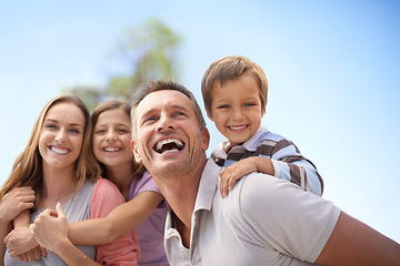 Image showing Family, piggyback and fun in outdoor on vacation, bonding and playful by blue sky on summer holiday. Parents, children and carrying game on weekend, nature and support on adventure and laughing