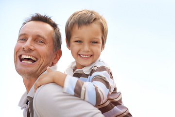 Image showing Father, son and piggyback in portrait on vacation, bonding and playful by blue sky on summer holiday. Daddy, child and carrying game for fun, nature and support on adventure and laughing on weekend