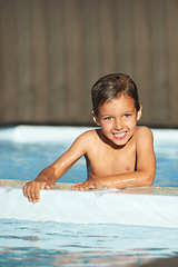 Image showing Portrait, little boy and happiness in swimming pool, resort and lodge for recreation, summertime and relaxation. Male child, youth and poolside at vacation, holiday and cheerful outdoors in Florida