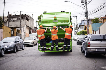 Image showing Industry, waste management and garbage truck with people in uniform cleaning outdoor on city street. Job, service and men working with rubbish for sanitation, maintenance or collection of dirt.
