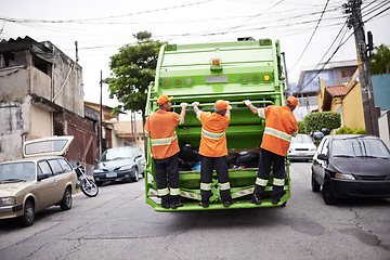 Image showing Industry, waste management and garbage truck with men in uniform cleaning outdoor on city street. Job, service and male people working with rubbish for sanitation, maintenance or collection of dirt.