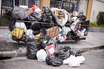 Image showing Garbage, street and bags with trash, pile and dirty with recycling, New York city and environment. Container, waste management and dumpster on the sidewalk or pavement with pollution, road or plastic