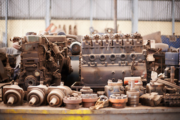 Image showing Recycle, scrap metal and rust in workshop at junkyard for sorting, garbage and at trash at landfill site. Steel, iron factory and engine parts on table in plant with mechanic machine at waste dump.