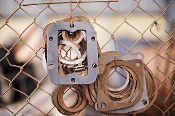 Image showing Fence, car gasket throttle and engineering in a scrap yard and mechanic equipment with vehicle industry. h.Hanging engine parts, metal and recycling with steel and copper with rust, alloy and metal