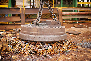 Image showing Recycle, metal and rust on magnet in junkyard for sorting, garbage and scrap reuse at landfill site. Steel, iron and industrial electromagnet excavator for urban pollution at waste dump with machine