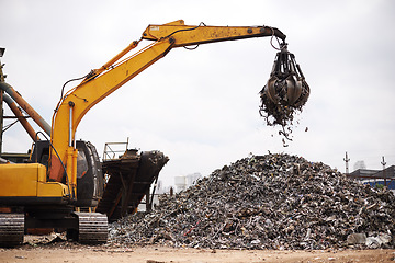 Image showing Crane, vehicle and junkyard for moving metal with sustainability, manufacturing or stop pollution. Machine, tractor and outdoor in scrapyard, plant or ecology for iron, steel industry and environment