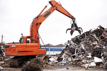 Image showing Crane, vehicle and junkyard to recycle metal with sustainability, manufacturing and stop pollution. Machine, tractor and scrapyard for ecology at plant with iron, steel and industry in environment