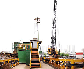 Image showing Construction, industry and crane in junkyard for recycling, maintenance and pollution control. Building, machine and manufacturing concept in scrapyard for trash, upcycling and garbage disposal