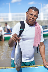 Image showing Portrait, sea and fisherman with fish on boat in nature outdoor to travel in summer. Person, man or animal at ship in ocean, food or fresh catch with face of serious angler working by water in Brazil