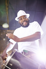 Image showing Portrait, drum or festival with a black man playing an instrument in a carnival in Rio de Janeiro. Brazil, night show or party with a musician, performer or artist banging to create a beat or rhythm