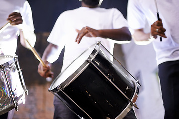 Image showing Hands, drum or festival with a band playing an instrument in a carnival in Rio de Janeiro, Brazil. Night show, person or party with a musician, performer or artist banging to create a beat or rhythm