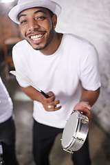 Image showing Happy, man and music on drums for carnival, festival or performance with band at party. Night, club and musician smile in portrait with instrument for playing creative samba or salsa beat with rhythm