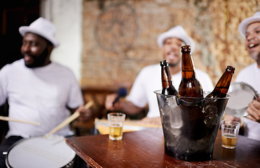 Image showing Musician, band and friends with drink, men and happy for drums, performance and party with alcohol. Group, artist and singing with bottle, beer and relax in pub for social event in Rio de Janeiro
