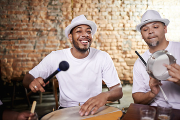 Image showing Happy, man and music on drums for carnival, festival or performance with band at party. Night, club and musician smile in portrait with instrument for playing creative samba or salsa beat with rhythm