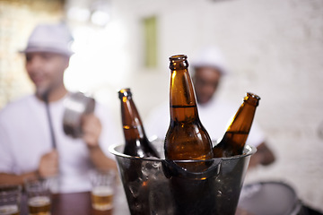 Image showing Beer, bottle and musician in performance at club on drums for carnival, festival or party. Night, club and event with alcohol closeup with people with creative energy, samba or salsa beat with rhythm