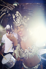 Image showing Dancer, night or happy woman in carnival in a performance, smile or culture in an event or band. Music, samba or excited people dancing at party for celebration with drums in Rio de Janeiro, Brazil