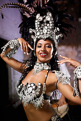 Image showing Dancer, carnival and woman in portrait with confidence, pride and culture in concert for music performance in night. Person, girl and stage at event, party and smile at celebration in Rio de Janeiro