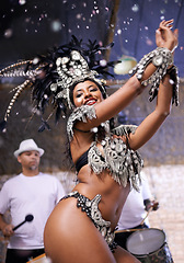 Image showing Dancer, carnival and girl in performance with band, feather crown and pride for culture in low angle in night. Person, woman and stage at event, party and music for celebration in Rio de Janeiro