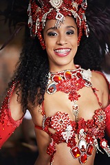 Image showing Dancer, carnival and girl in portrait with smile, pride or culture with glow for street performance in night. Person, fashion and woman at event, party or celebration with tradition in Rio de Janeiro