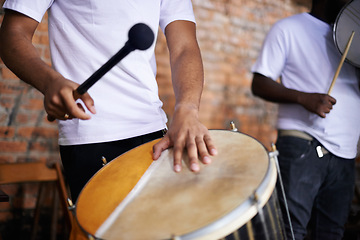 Image showing Hands, drum or carnival with a person playing an instrument in a festival in Rio de Janeiro, Brazil. Closeup, band or party with a musician, performer or artist banging to create a beat or rhythm