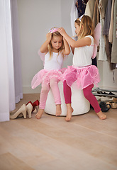 Image showing Girl, sister and play with fairy costume in bedroom of home for dress up, fantasy fun and tiara with relax. Family, children and face with princess outfit for bonding, fashion and care with wings