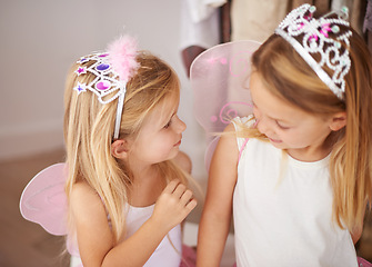Image showing Girl, sister and play with fairy costume in bedroom of home for dress up, fantasy fun or tiara with smile. Family, children and face with princess outfit for bonding, fashion or happy with wings