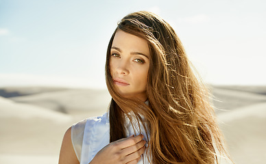 Image showing Portrait, desert and woman with holiday, sunshine and weekend break with long hair on getaway trip. Face, person and girl with vacation and summer with wind and outdoor with nature or relaxing