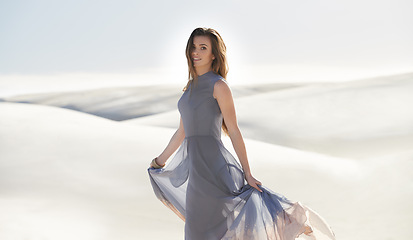 Image showing Portrait, desert and woman with holiday, fashion and weekend break with sand and getaway trip. Face, dress and girl with vacation and sunshine with travel and outdoor with nature and tropical island